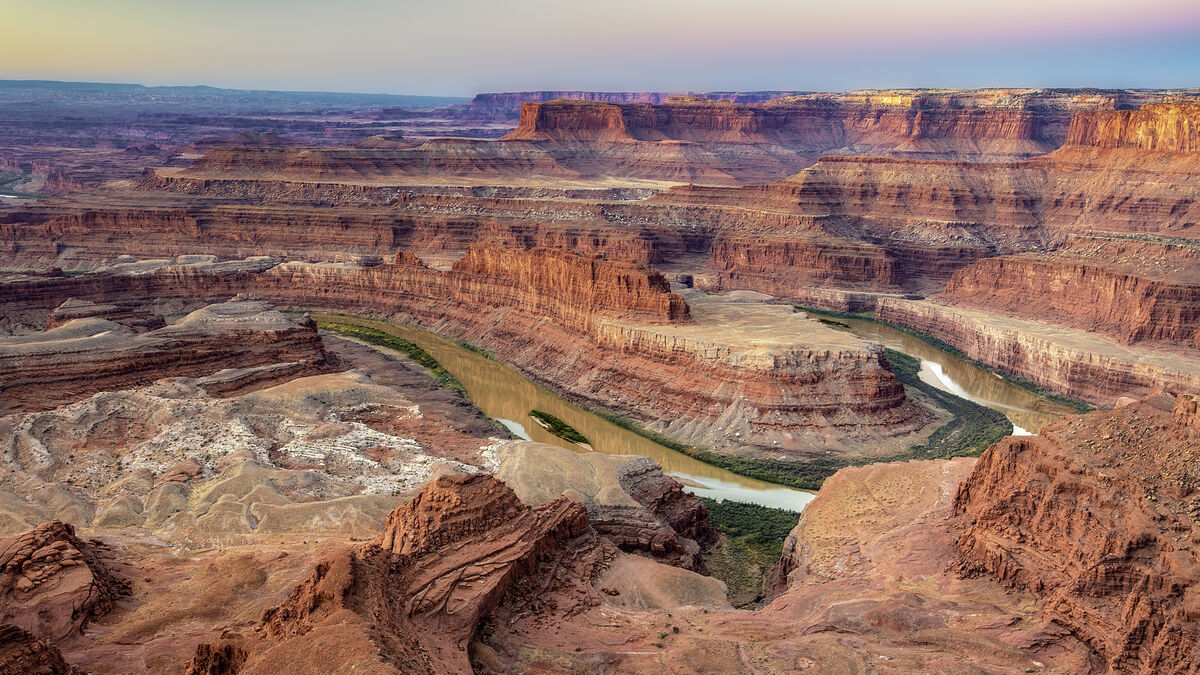 Just before sunrise at Dead Horse Point, the soft ...