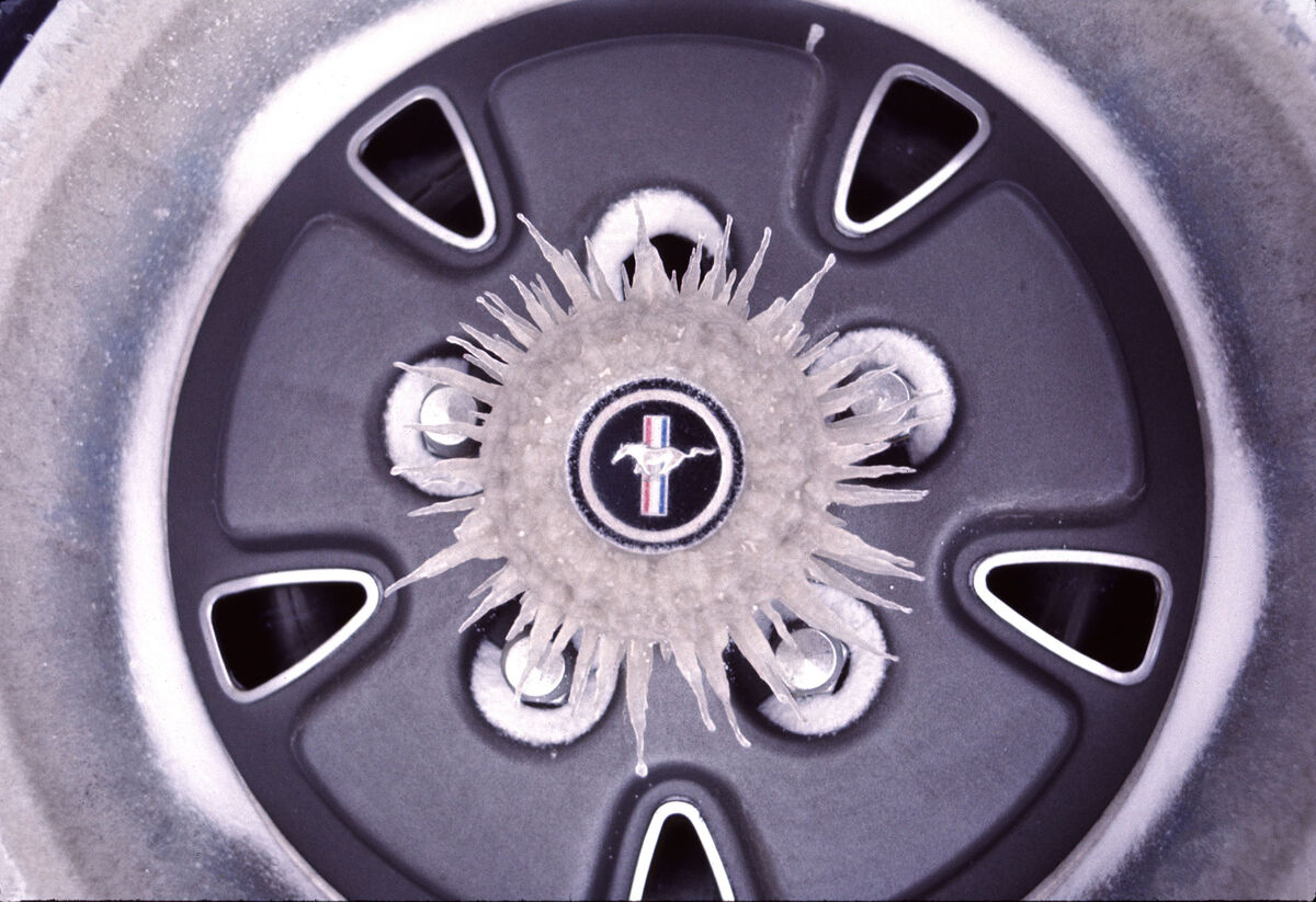 Icicles on the hubcap of a Ford Mustang, shot near...
