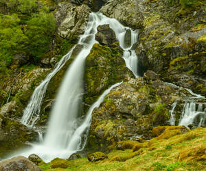 Waterfall of a stream flowing from the base of the...