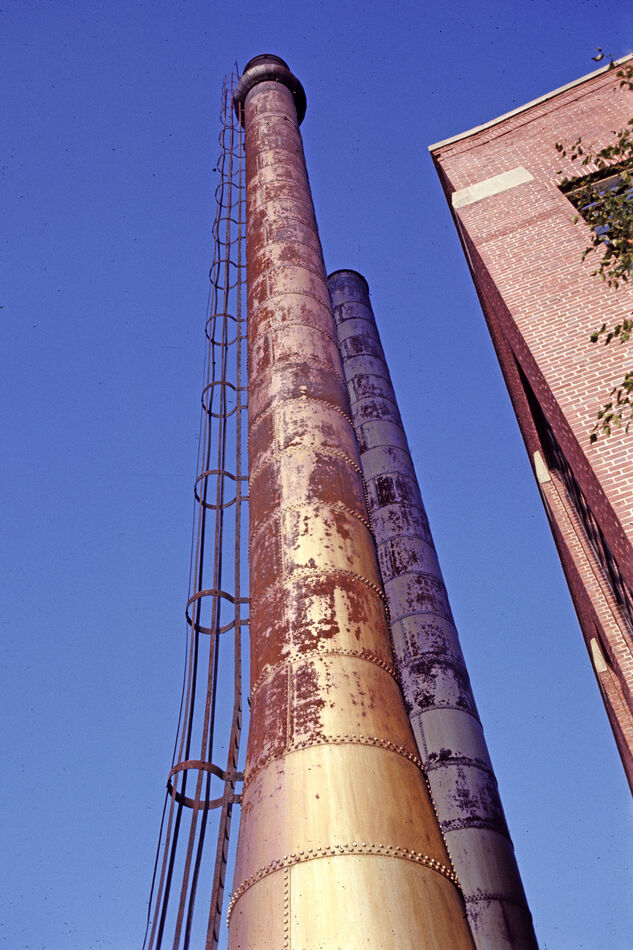 Looking up the side of a couple of smokestacks at ...