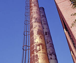 Looking up the side of a couple of smokestacks at ...