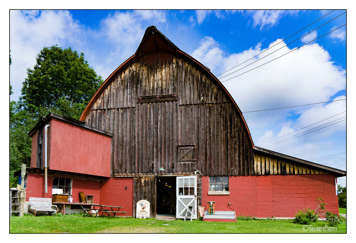 A nice barn that is now an antique store and the old storage shed next ...